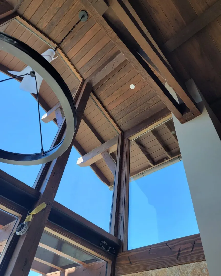 Close architectural view of a circular window integrated into exposed timber framing.