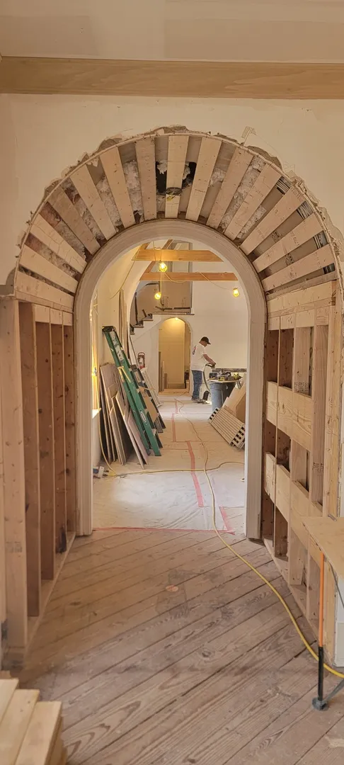 Arched passage framing and backing prepared for finish millwork.