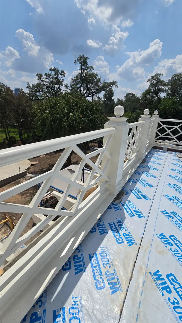 White Chippendale-style terrace railing at the Niles project.